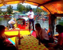 Photo of Our food being prepared in the little boat behind us. An excellent lunch with complimentary drinks followed by another boat later with a marichachi band. Life is good. , samgabe - June 2016