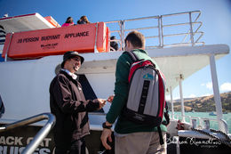 Photo of Our excellent and friendly Skipper - Julian taking tickets Recent Hector Dolphin Cruise , shadania - February 2015