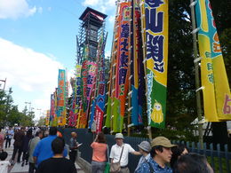 Photo of Arriving at the Sumo tournament This is outside the Kokugikan Stadium as we arrived, there were a lot of people waiting around outside to see their favourite Sumos. It was very colourful with lots of market food stalls as well. , Leanne M - October 2013