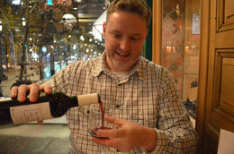 Photo of Seine River Cruise, Paris Illuminations and Dinner on the Champs-Elysees Ryan pours the wine with the Champs Élysées in the background. - January 2014