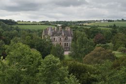 Photo of Blarney Castle Behind the Blarney ruins this amazing castle appears - still lived in by descendants of the original occupants - June 2011