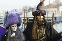 Photo of Celebrating Carnival Wearing carnival masks, San Giorgio Maggiore church in the background, Venice, Italy - May 2011