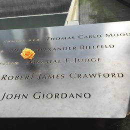 Photo of 9/11 Memorial When it's a person's birthday, they place a flower on their name. This man was a fire chaplain. , Ruth D - August 2016
