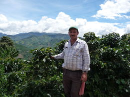 Photo of Alonso: Colombian Coffee Grower The coffee grower, Alonso explaining coffee production with the magnificent view in the background. , William M - September 2013