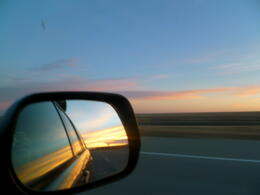 Photo of Sunset on the Road to Oklahoma We saw so many beautiful skies during our four-day road trip, but this sunset in Texas has to be one of the most beautiful. I couldn't resist catching a forwards and backwards view simultaneously. , JackieD - March 2011