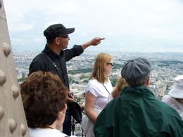 Photo of Our guide, Paris day trip from London Our guide shows us the view of Paris from the Eiffel Tower - July 2009