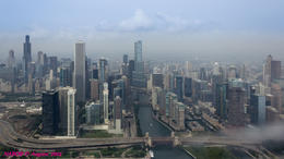 Photo of Chicago City Skyline Chicago City Skyline viewed while flying over the Chicago River Locks at Lake Michigan. Note the fog rolling off the lake. , N Robert A - August 2014