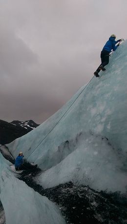 Photo of Ice climbing on the Sólheimajokull glacier My attempt to scale the ice with our guide Snorri belaying (no he's not sitting down, his foot had just sunk a bit deeper into the snow!) , Matthew B - February 2015