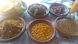 Photo of food in the restaurant Beautiful chicken tagine, mixed salad, lentils, beans, meatballs, cous cous with veg and plenty of bread and oil. Drinks are extra but not a bad price about 30/40 dirhams 2/3 for a small beer to ... , Roy T - December 2015