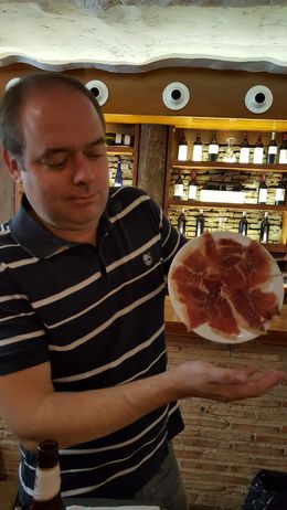 Photo of Jamon Iberico de Bellota Our guide Pedro demonstrating how the best jamon would stick to the plate. , Areocat - January 2016