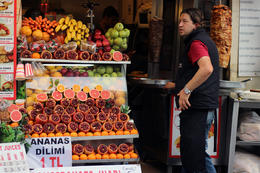 Photo of Fresh squeezed juice A vendor stands near his stall serving freshly squeezed orange and pomergrenate juice and donor kebabs , Prezzman - June 2014