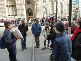 Photo of The Wall Street Experience - listening to our guide Here we are standing and listening to our guide Sandy. He had some great stories to tell. , Peter M - March 2012