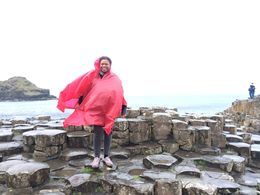 Photo of Me at Giants Causeway I am at Giant's Causeway with my very useful rain poncho. The wind was pretty wild. , Alyson T - May 2015