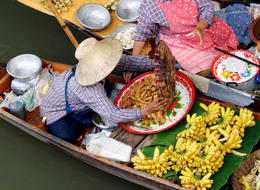 Photo of Woman Trading Food at Floating Market Woman engaged in trade at floating market near Bangkok, Thailand - June 2011