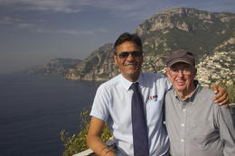 Photo of our new best friend on the Amalfi Coast! My dad and Johnny with the beautiful bay behind them! , Julie L - October 2014
