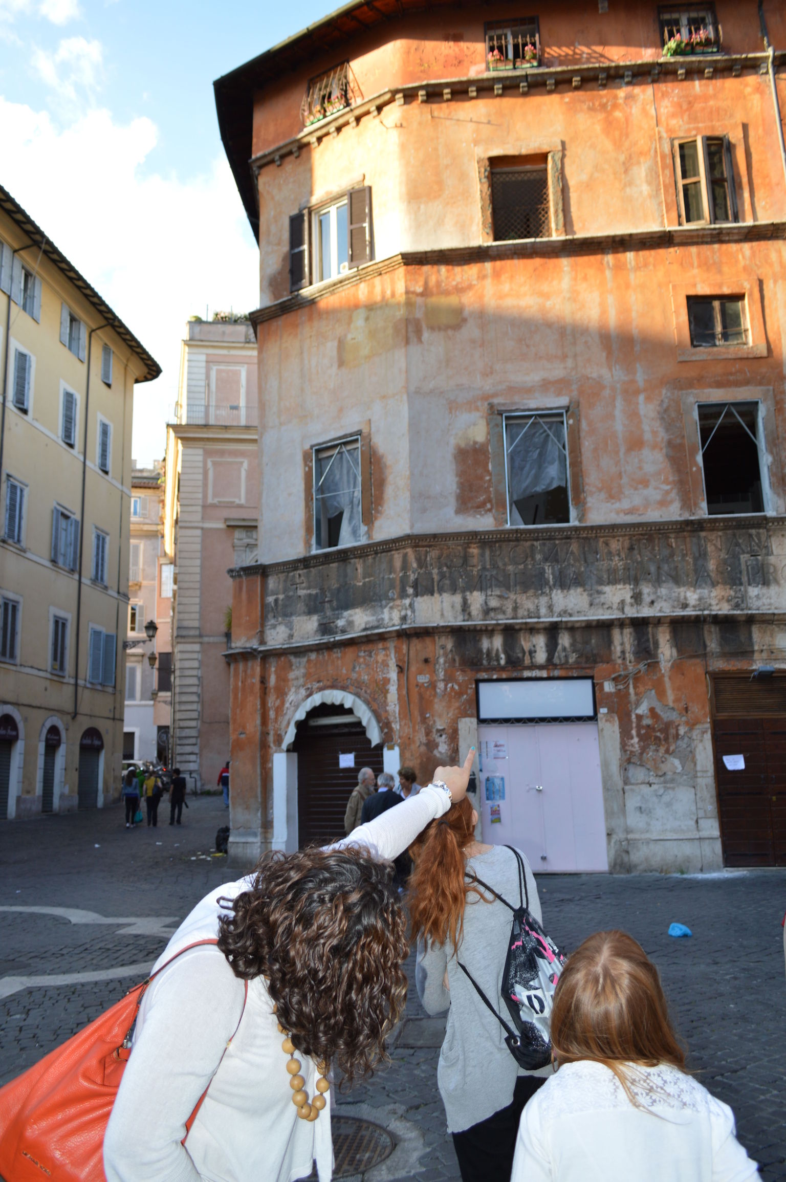 Tour guide pointing to building in Jewish ghetto