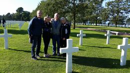 Photo of At the American Cemetery Ann-Sophia took us to the American Cemetery at the end of our day when they were lowering the American Flag and playing Taps. A very special time for us. Photo of Jim Houghton and Connie Nelson, ... , Judy H - October 2015