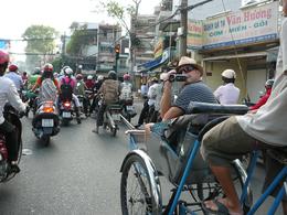 Photo of Pedal Power: cyclo tour of Ho Chi Minh City My husband on a cyclo amidst the masses of scooters. , Leanne B - April 2011