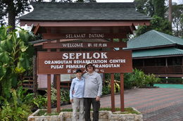 Photo of Short visit to Sepilok Orang Utan Rehabilitation Center Sylvain and Manon at the entrance of Sepilok , Jean-Guy R - May 2016