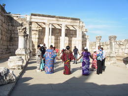 Photo of The ruins of the celebrated great Synagogue in Capernaum. Ladies are singing and pray and they picked up pebbles as a precious stone. , Yoshiko O - November 2013