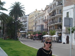 Photo of Line of restaurants next to Sitges beach My wife stands in front of the line of restaurants that are the backdrop to the beach at Sitges. A really nice contrast with the beach. , David F - August 2011