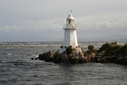 Photo of The lighthouse at Devils Gate This is the entrance to Macquarie Harbour, a very rough patch of see, but not this day! , RobC - December 2010