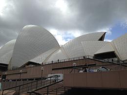 Photo of Sun light through the rain clouds Simply a photo of the Opera House sails taken during a break in the rain; just as the sun attempted to break through - unsuccessfully I may add. , Barbara H - November 2014