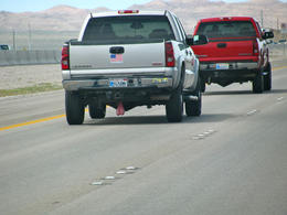 Photo of Only in the USA Driving to Vegas, we saw this typical US pick-up, complete with the USA flag on the rear, and an extra appendage..... , Peter Whitten - March 2011