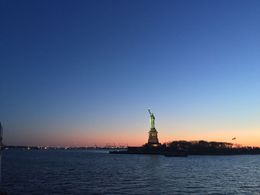 Photo of A view of the Statue of Liberty at Sunset A view of the Statue of Liberty at Sunset. This was taken with my iPhone - as I didn't have a better camera with me. With a better camera you can get a very good view of the statue. It appears much, ... , Holly C - April 2016