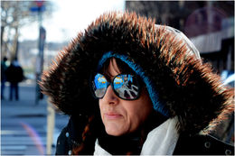 Photo of Lady K Fever The photo shows Lady K Fever, a Canadian Street artist now living in East Harlem, our tour guide on the walk. Her glasses reflect the mural of Booga, a local, who was shot by a retired policeman ... , Tracey A - February 2015