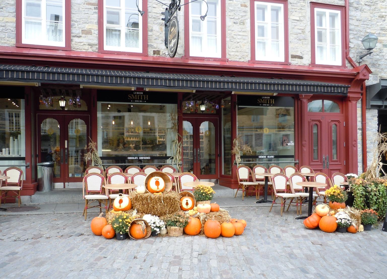 A shopkeeper in Petit Champlain welcomes fall visitors to his place.