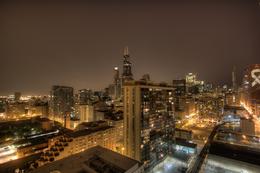 Photo of Chicago at night This photo was taken from the roof of our apartment. You can see iconic buildings like the Willis Tower, Trump Tower, Dearborn Station, CNA, the library, and our famous and quot;L and quot; tracks ... , Kim - March 2011