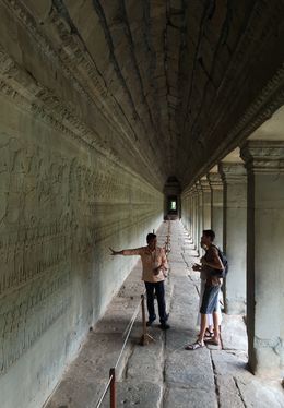 Photo of Angkor Wat Temples Tour Our tour guide, Chet, explains the story portrayed in relief on the wall. , Cherie R - July 2015