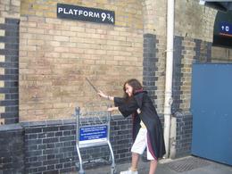 Photo of Entering Platform 9 3/4 Playing make believe at a location in King Cross station purported to be platform 9 3/4, but we know better now don't we?, Stuart L - July 2008