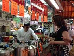 Photo of Herbal tea stall on Shanghai Street Ruth Smart sampling the Pear and Chrysanthemum tea. Very refreshing :-) , Ruth S - March 2013