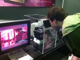 Photo of Examining Data Daniel checking out fibers through the microscope, JennyC - February 2011