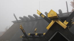 Photo of Shinto shrine roof in the fog When we got to the Fifth Station of Fuji on October 31st, clouds and/or fog had completely envoloped the mountaintop. While walking around, i visited the Shinto shrine that is there and the gold ... , stephen b - November 2014