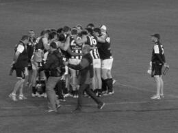 Photo of Quarter time huddle. While your team are getting instructions, a good time to slip out to the shop for a beer, pie and sauce. Essential footy food. , ROD C - August 2011