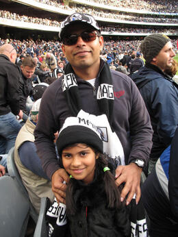 Photo of Pies Supporters! Balaji and Kavya in Collingwood hats and scarves; Magpies fans since they moved to Melbourne a few years ago. Good choice. , ROD C - August 2011