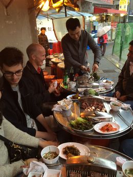 Photo of Korean BBQ Joon, our tour guide, showing us how to prepare Korean style bbq. Lots of accompaniments to the meat and mushrooms - had no idea you ate this inside a lettuce or mint leaf. , Jan - April 2015