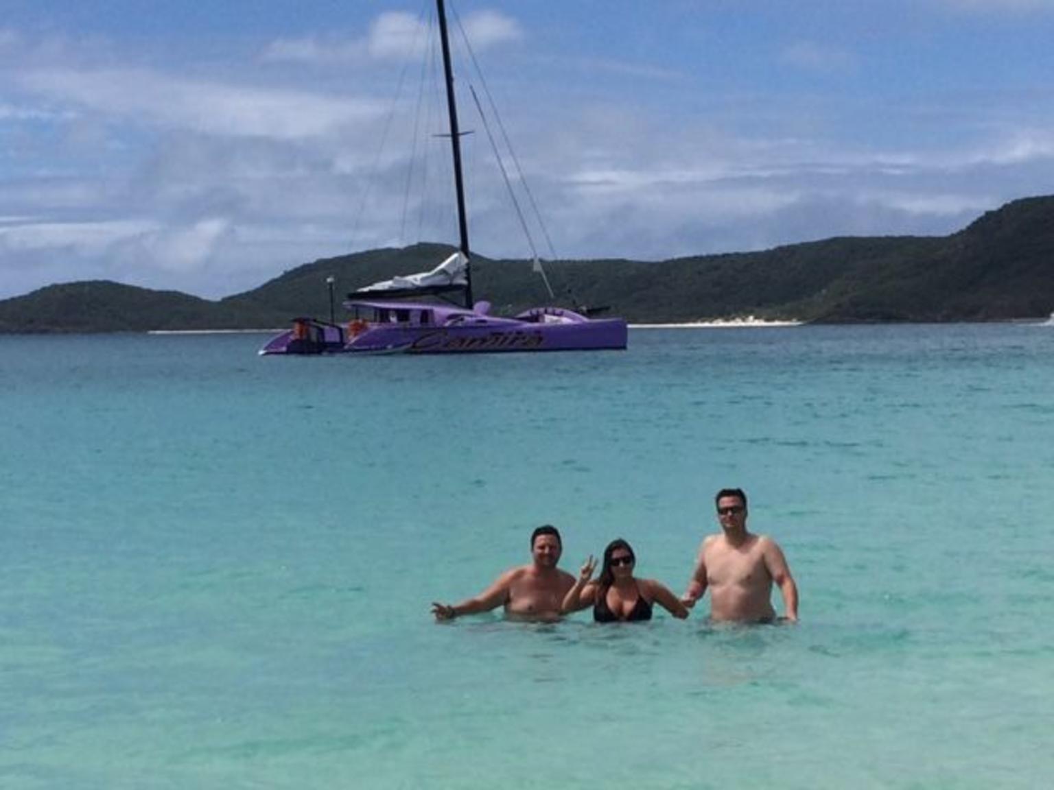 Fun in the sun at Whitehaven Beach with our boat Camira in the background