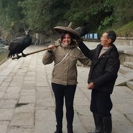 Photo of Me holding a Cormorant Fisher's pole Take your photo holding a Cormorant Fisher's Cormorants for 5¥ when you get off the cruise...if you are extra nice he may let you wear his hat too :P , Amy-Claire - March 2014