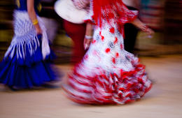 Photo of Flamenco dress - motion blur Two women walking in traditional Spanish Flamenco dresses during Feria de Abril, Seville - June 2011
