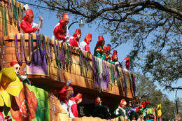 Photo of A Mardi Gras float rolls through New Orleans throwing beads to the crowd A Mardi Gras float rolls through New Orleans throwing beads to the crowd - May 2011