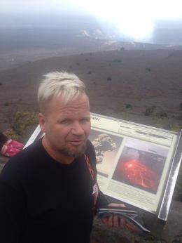 Photo of Big Island volcano tour as a day trip from Oahu Henry Stonie reading about kilauea volcano crater rim while in the distance there is a steam coming out of the crater. , Lucho - January 2015