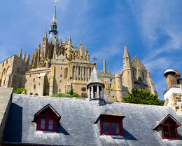 Photo of Mont Saint Michel The Mont Saint Michel Abbey with a typical wooden roof from Brittany in the foreground - May 2011
