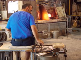 Photo of Artisan blowing glass Here is a photo I took of one of the glass blowers working with the glass. He literally did blow the glass, and made a vase in front of our eyes. Amazing! , Sarah J - July 2016