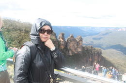 Photo of 1 My wife in front of the three sisters. 2 We took the complete tour with sky way, cable way and train, plus we finish by the cruise on Sydney Bay. Hre is the top in front of the three towers. , Gerard A - September 2016