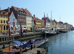 Photo of Copenhagen This photo shows the most famous canal scene in Copenhagen complete with a canal boat full of passengers. The photo was taken at one of our stops on the Grand Copenhagen Tour. , Gerald H - June 2011