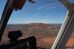 Photo of Uluru from 2500 feet This is how we were introduced to Uluru - a wonder on the middle distance as we flew in from Ayres Rock airport - the pilot positioning our helicopter to give all a great view. , Catherine E - February 2015